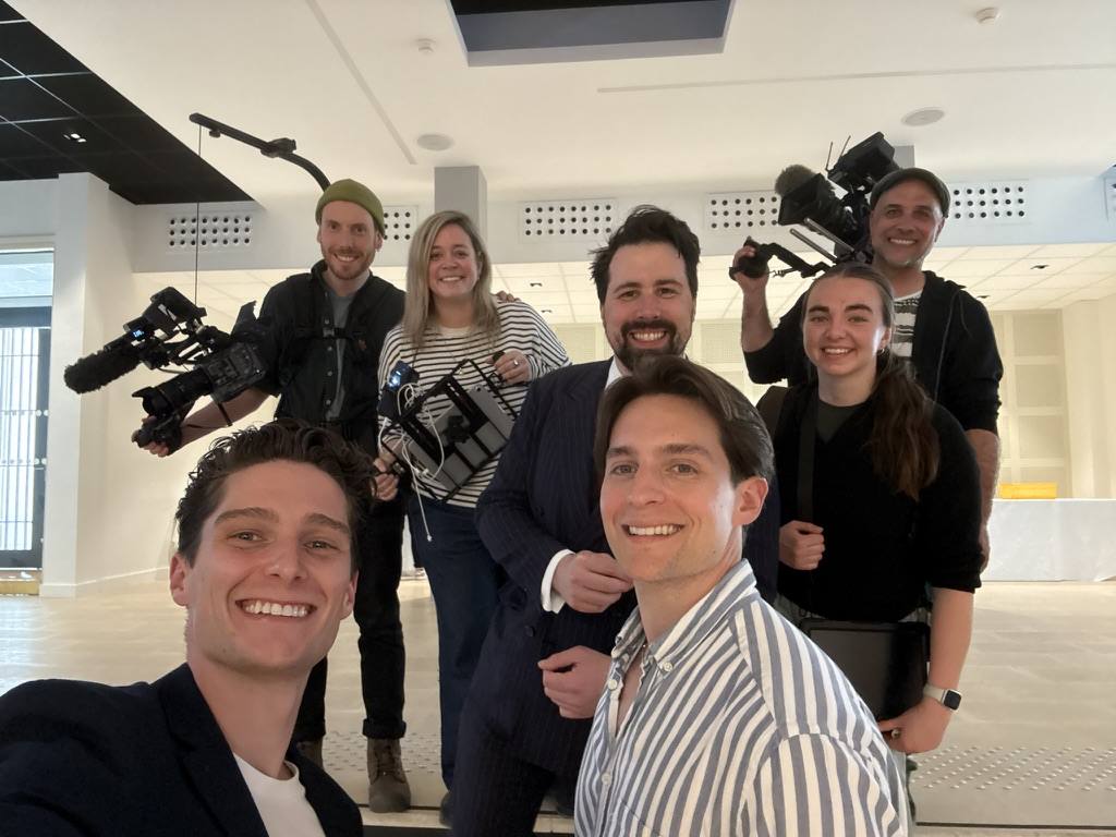 With a professional documentary film crew